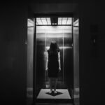 Horror photo of woman in the lift in wihte tone