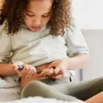 Diabetes, insulin and diabetic girl injecting treatment in her b